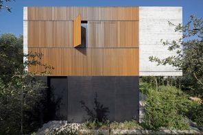 位于特拉维夫的木板条住宅是一座坚固的混凝土住宅，带有可折叠的木质百叶窗